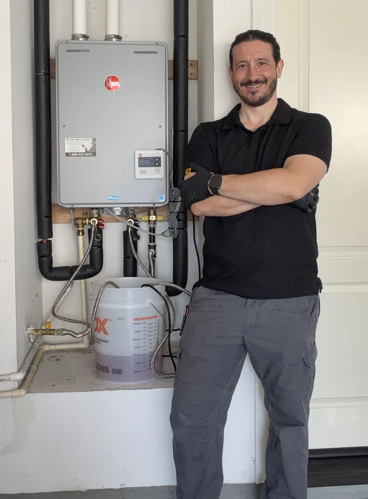 Dustin Swad of Ultra Home Repair performing a professional tankless water heater descaling flush on a Rheem Prestige system in Irvine