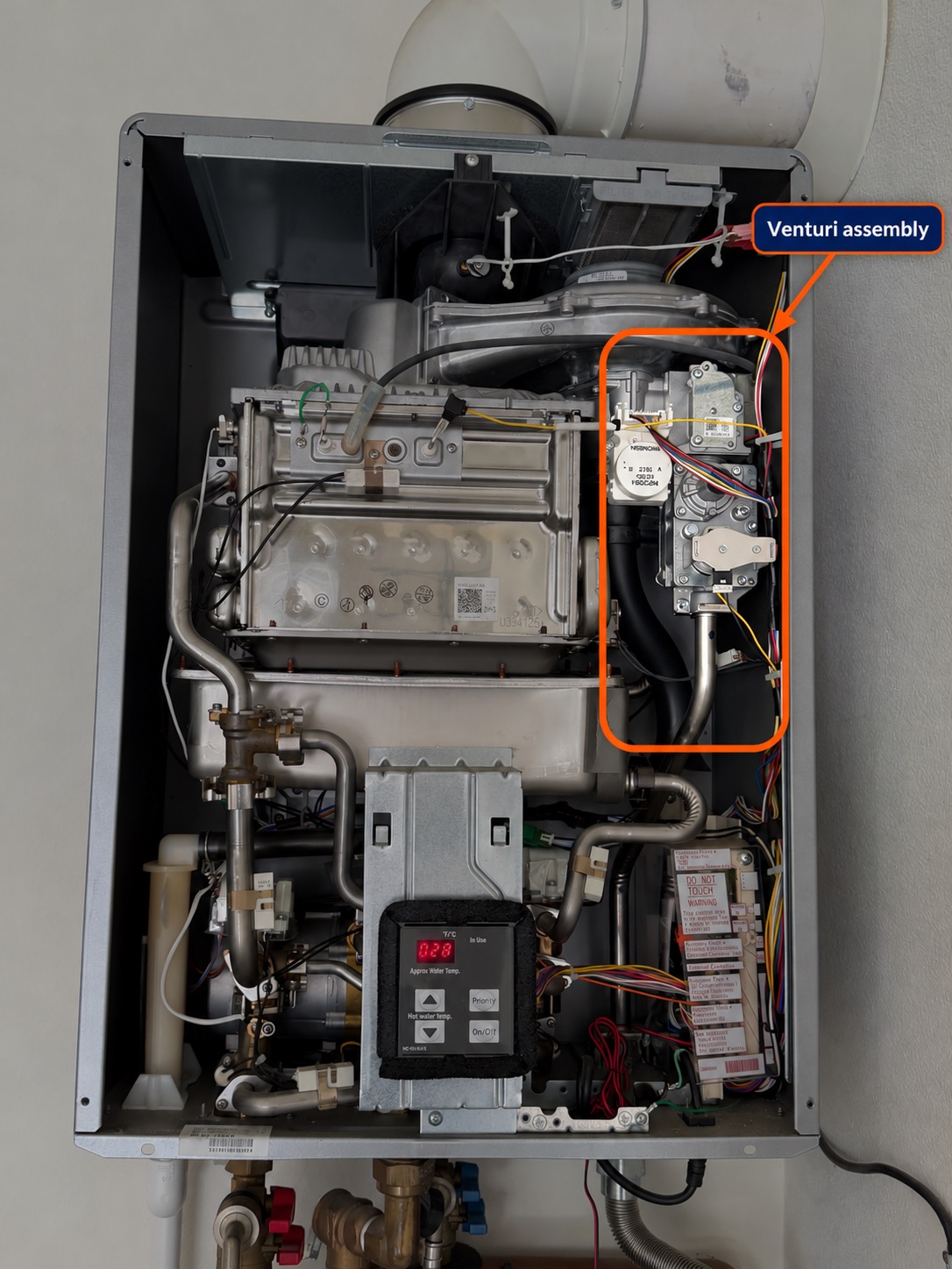 Open Rinnai tankless water heater with the Venturi assembly highlighted