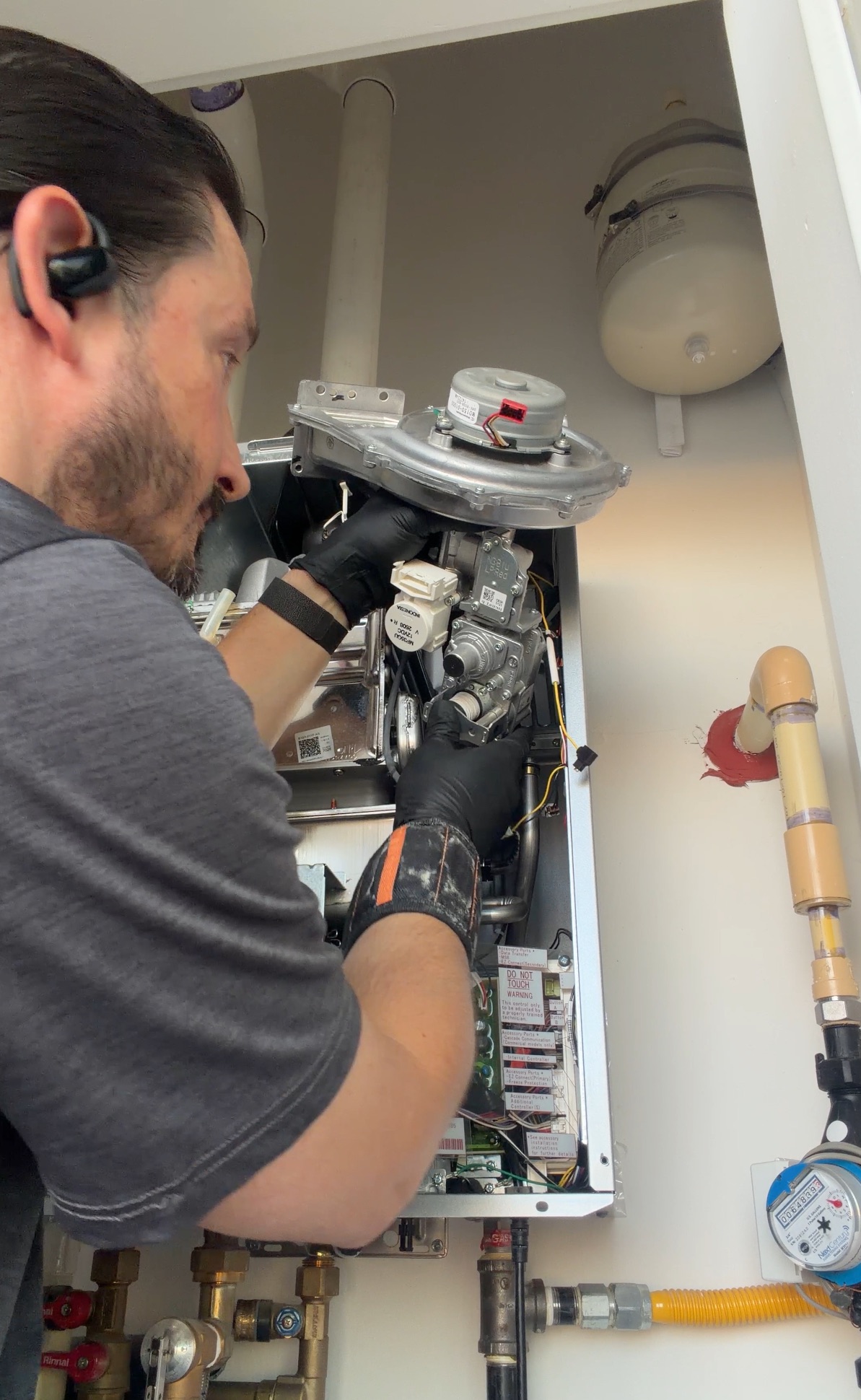 Dustin removing the Venturi assembly from a Rinnai tankless water heater